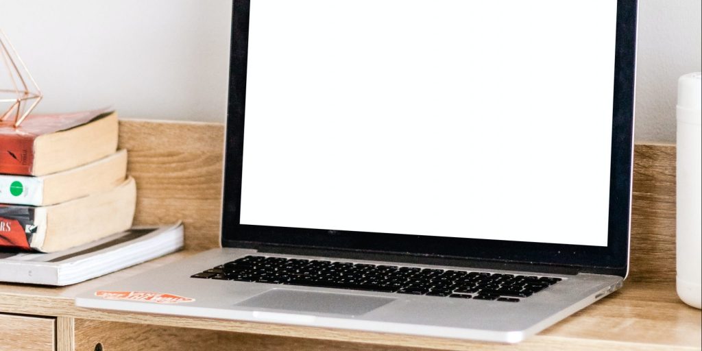 MacBook Pro on brown wooden table