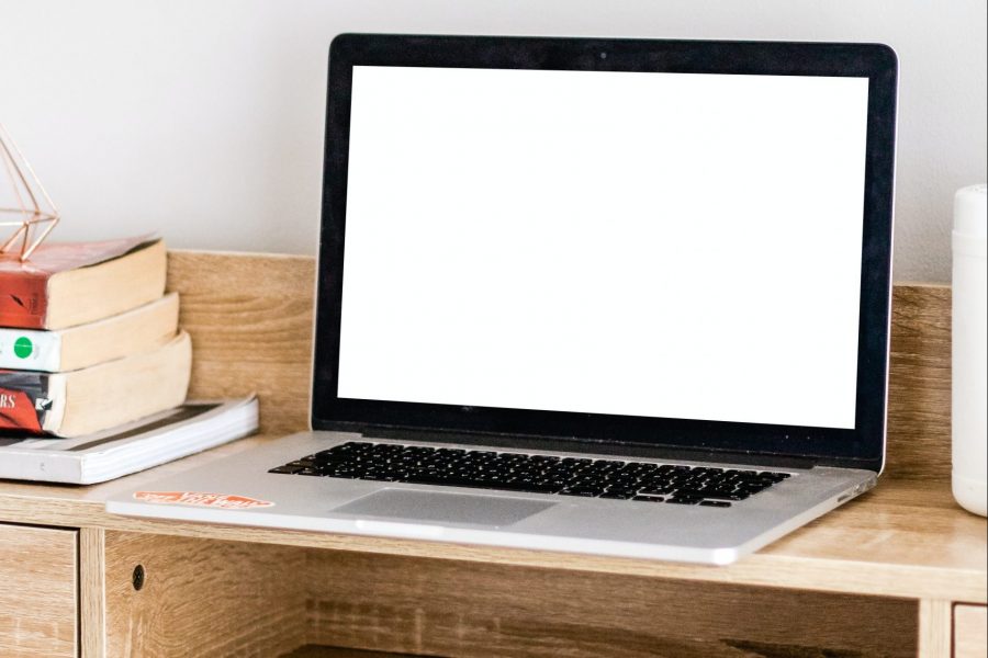 MacBook Pro on brown wooden table